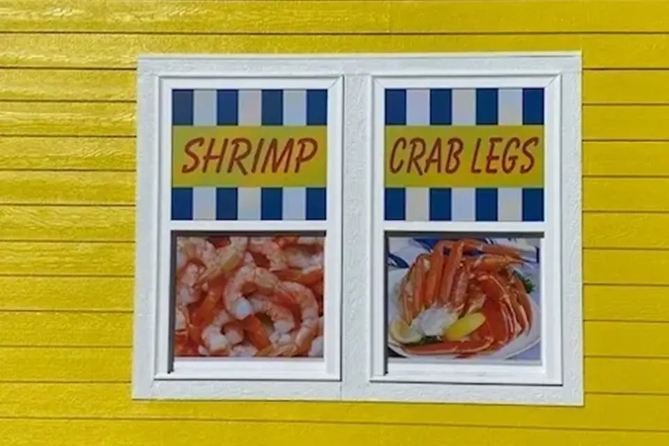A window with shrimp and crab legs on it.