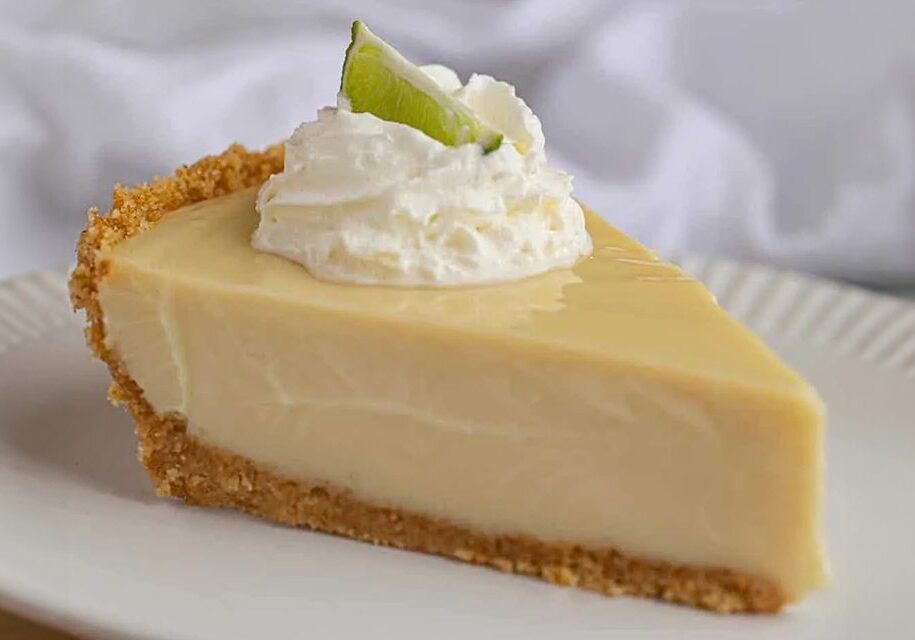 A slice of key lime pie with whipped cream on top.